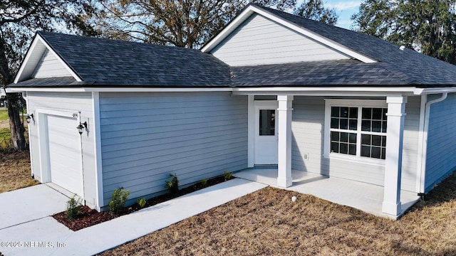 view of front facade featuring a garage and covered porch