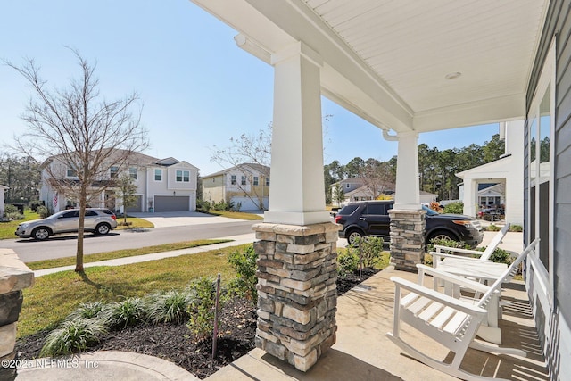 view of patio with a garage and covered porch