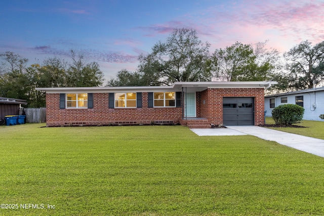 ranch-style house with a garage and a lawn