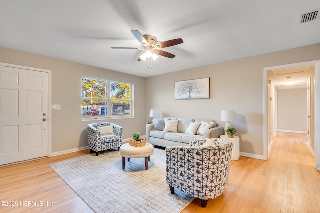 living room featuring ceiling fan and light wood-type flooring