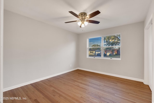 empty room with hardwood / wood-style flooring and ceiling fan