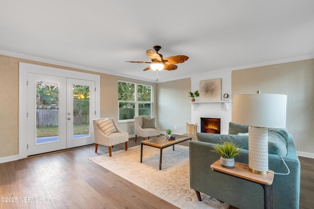 living room with hardwood / wood-style flooring, crown molding, and french doors