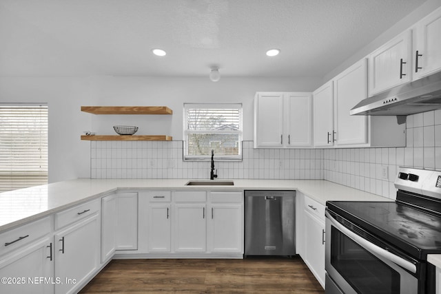 kitchen featuring dark wood-type flooring, sink, tasteful backsplash, stainless steel appliances, and white cabinets