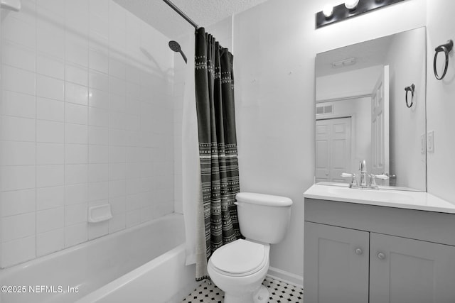 full bathroom featuring vanity, toilet, shower / tub combo, and a textured ceiling