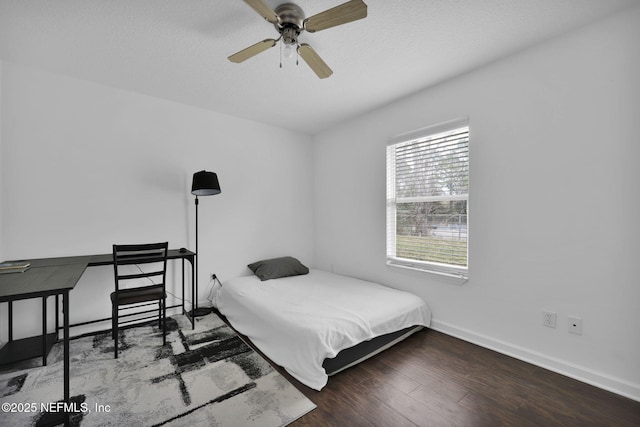 bedroom with hardwood / wood-style floors, a textured ceiling, and ceiling fan