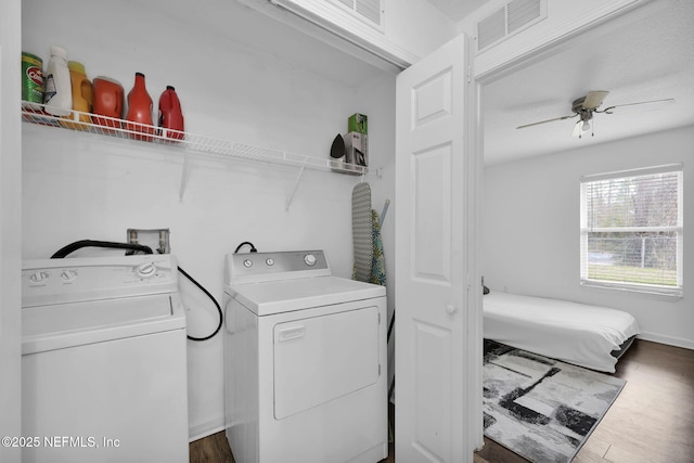 laundry area with dark hardwood / wood-style flooring, ceiling fan, and washing machine and clothes dryer