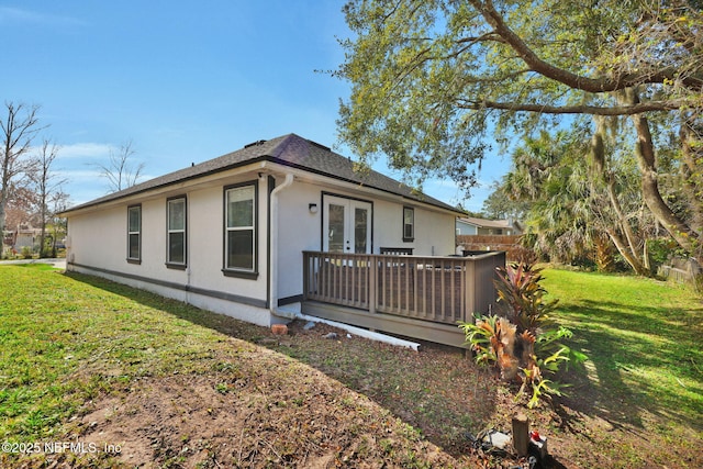 view of side of property featuring a yard and french doors