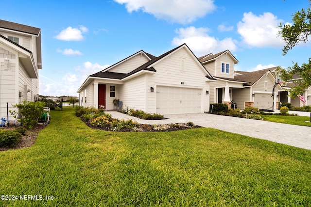 view of front of house featuring a garage, a front yard, and decorative driveway