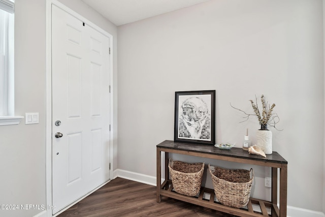 entrance foyer featuring dark wood-style floors and baseboards