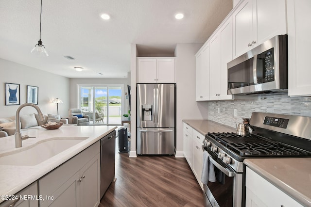 kitchen featuring visible vents, appliances with stainless steel finishes, open floor plan, and a sink