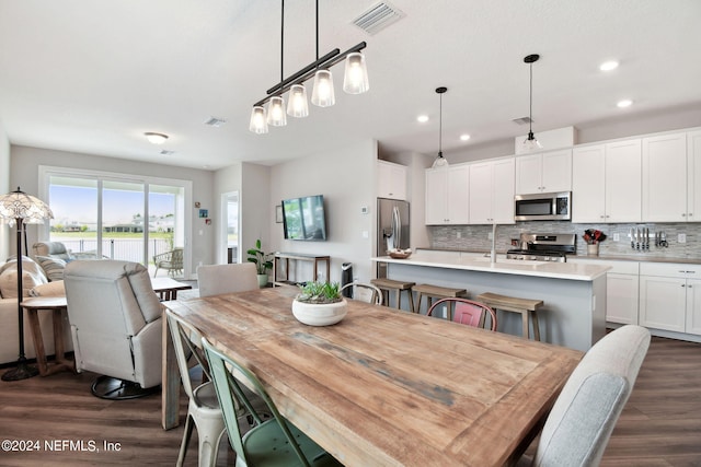 dining area with recessed lighting, visible vents, and dark wood finished floors