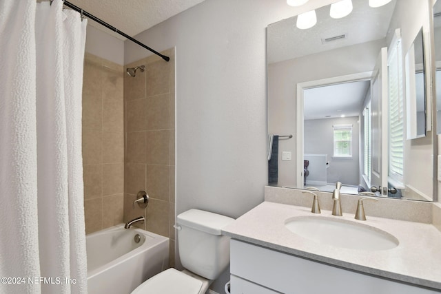 full bath with shower / tub combo, visible vents, toilet, a textured ceiling, and vanity