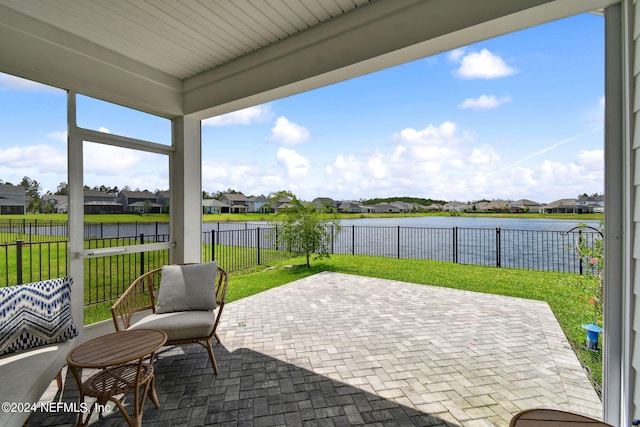 view of patio featuring a residential view, a water view, and a fenced backyard