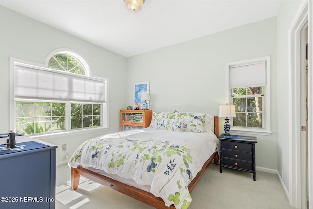 bedroom featuring light colored carpet