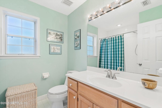 bathroom with tile patterned flooring, vanity, curtained shower, and toilet