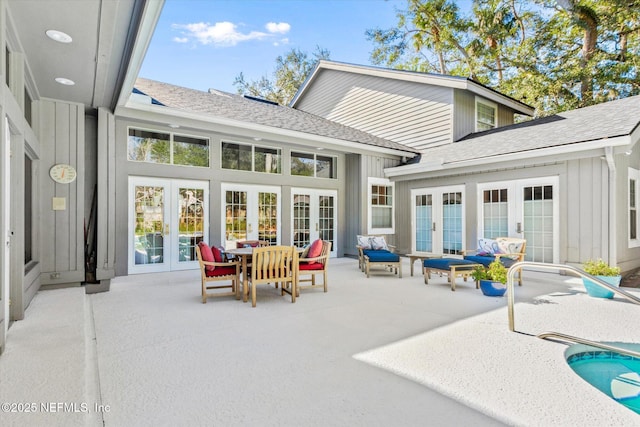 back of property with french doors and a patio area