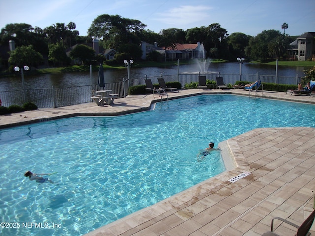 view of swimming pool featuring a water view