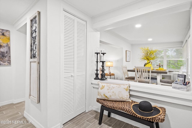 sitting room featuring wood tiled floor, baseboards, and recessed lighting