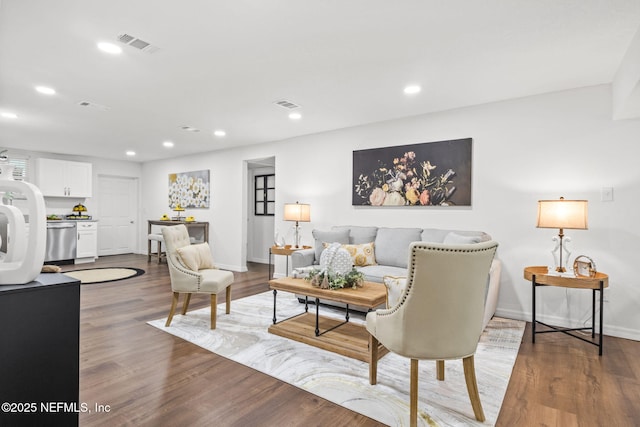 living room featuring wood finished floors, visible vents, and recessed lighting