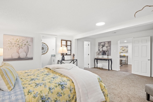 carpeted bedroom featuring baseboards and a textured ceiling