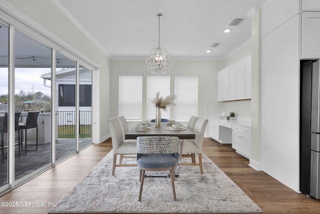 dining area with ornamental molding, dark hardwood / wood-style floors, and plenty of natural light