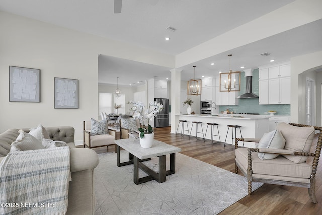 living room featuring a notable chandelier and light hardwood / wood-style floors