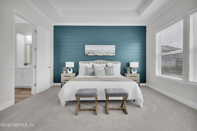 bedroom with multiple windows, light carpet, and a raised ceiling