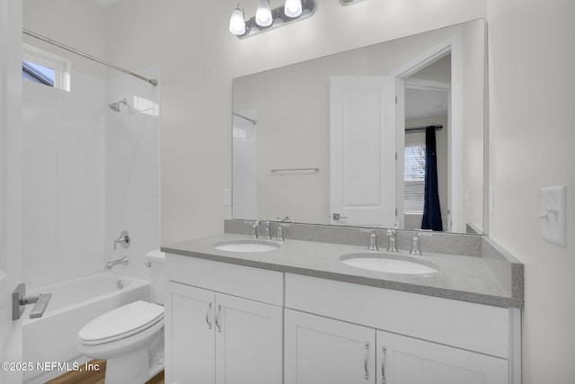 full bathroom with vanity, a wealth of natural light, toilet, and tiled shower / bath