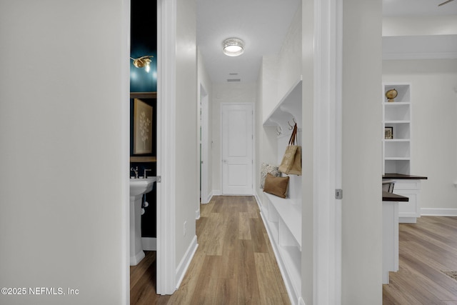 hall with light hardwood / wood-style flooring