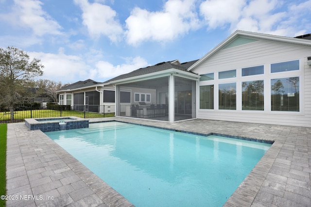 view of swimming pool featuring an in ground hot tub, a sunroom, and a patio area