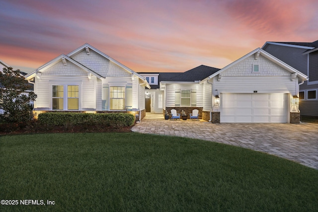 craftsman-style home with a garage and a yard