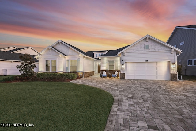 view of front of home featuring a garage and a lawn