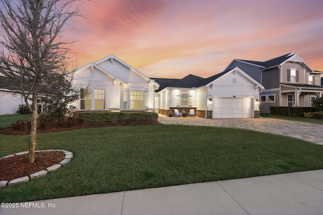 craftsman house featuring a garage and a yard