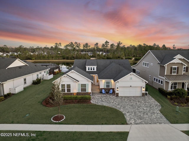 view of front of home with a yard and a garage