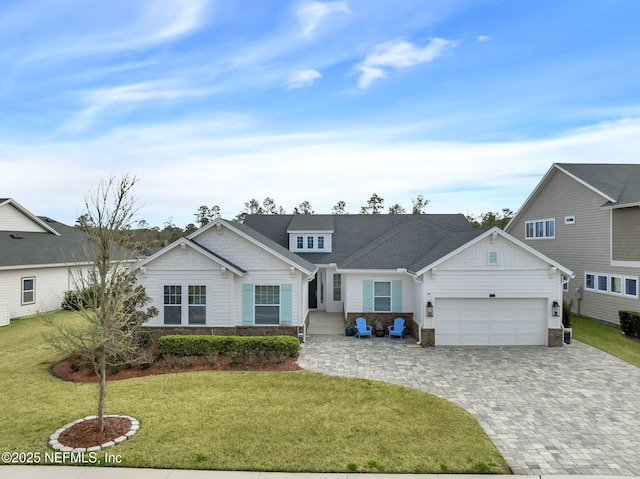 view of front of property with a garage and a front lawn