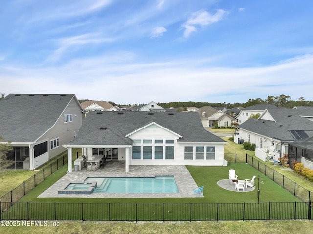 view of pool with an in ground hot tub, an outdoor fire pit, a lawn, and a patio area