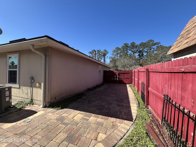 view of home's exterior featuring cooling unit and a patio area