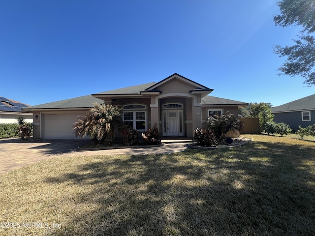 single story home featuring a garage and a front yard