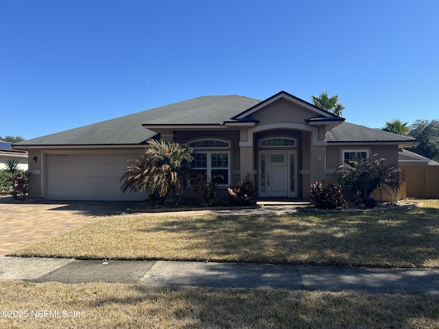 view of front of property featuring a garage and a front yard