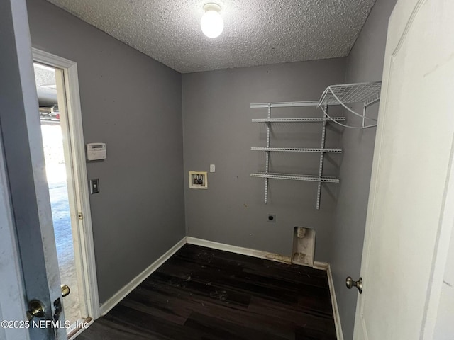 clothes washing area with hookup for a washing machine, dark wood-type flooring, hookup for an electric dryer, and a textured ceiling