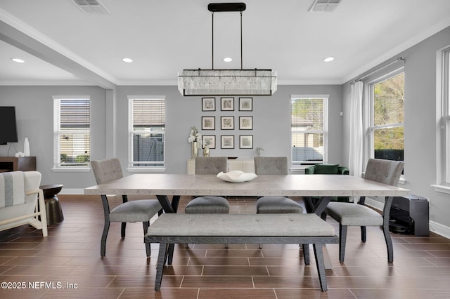 dining space with ornamental molding