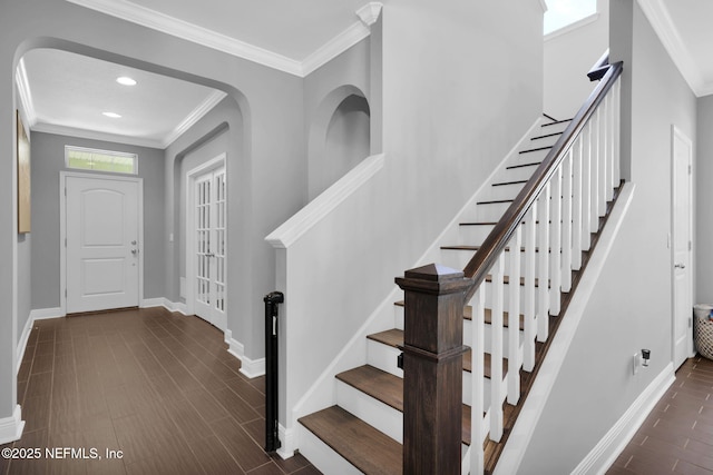 entrance foyer with dark wood-type flooring and ornamental molding