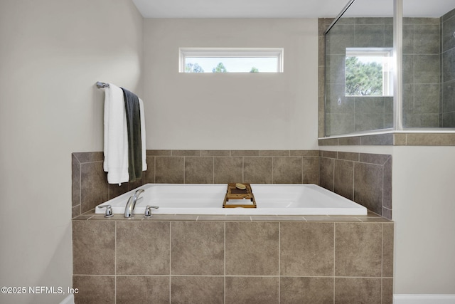 bathroom featuring tiled tub