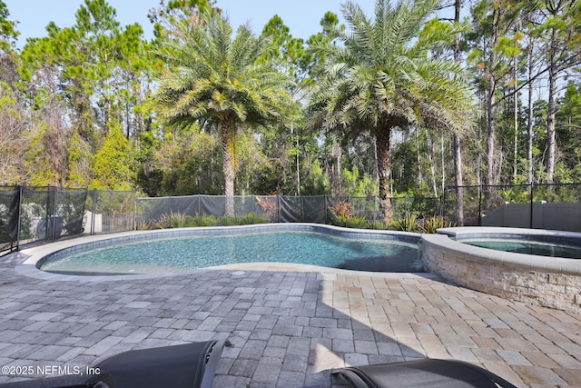 view of pool with an in ground hot tub and a patio area