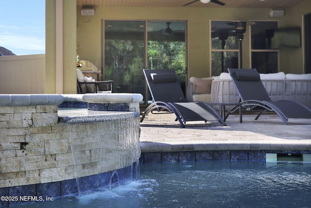 view of patio with pool water feature and ceiling fan