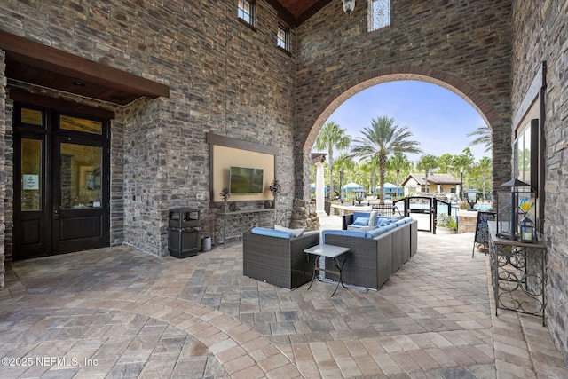 view of patio / terrace with an outdoor living space with a fireplace