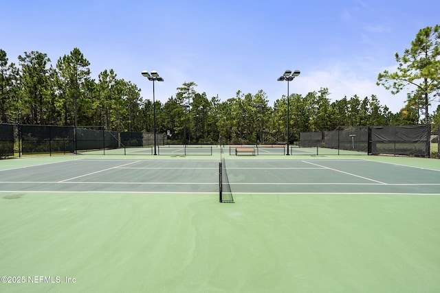 view of tennis court with basketball hoop