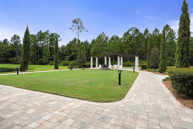 view of home's community with a yard and a pergola