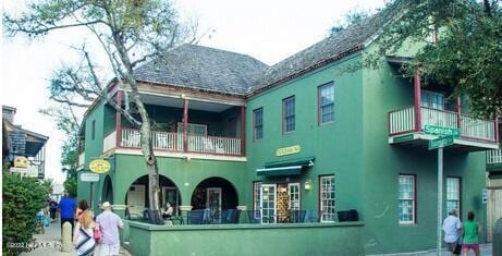 back of property with a balcony