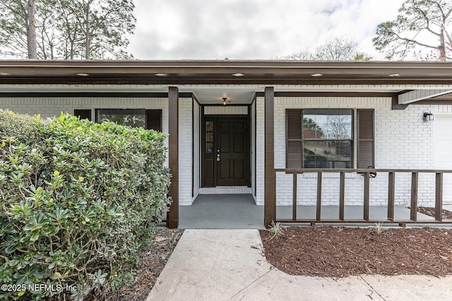 entrance to property featuring a porch